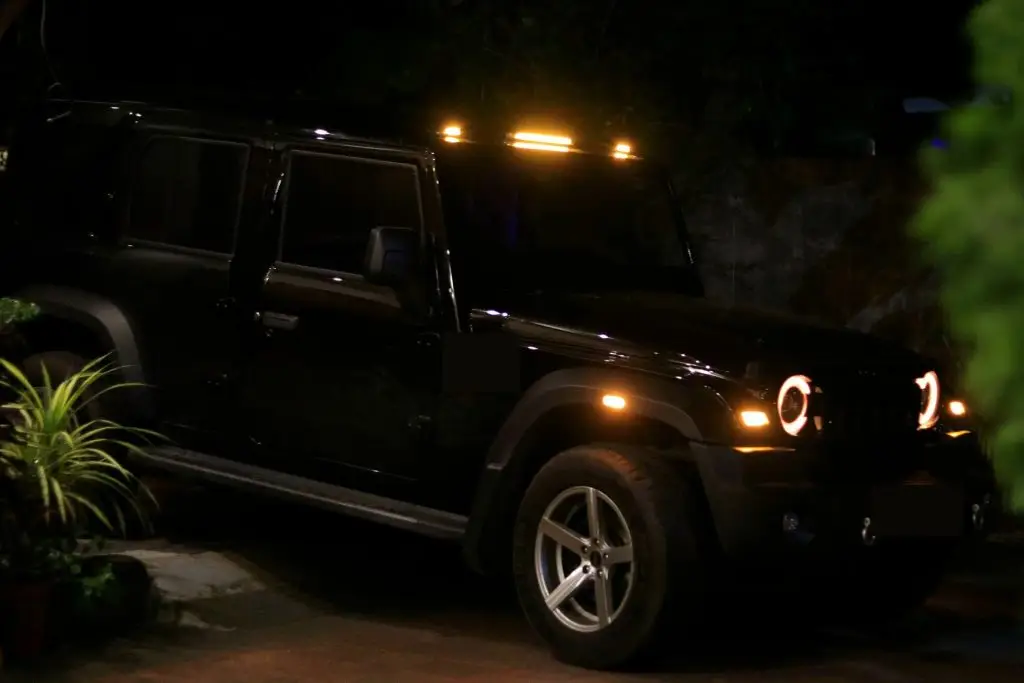 Patrol vehicle with amber roof lights parked at night